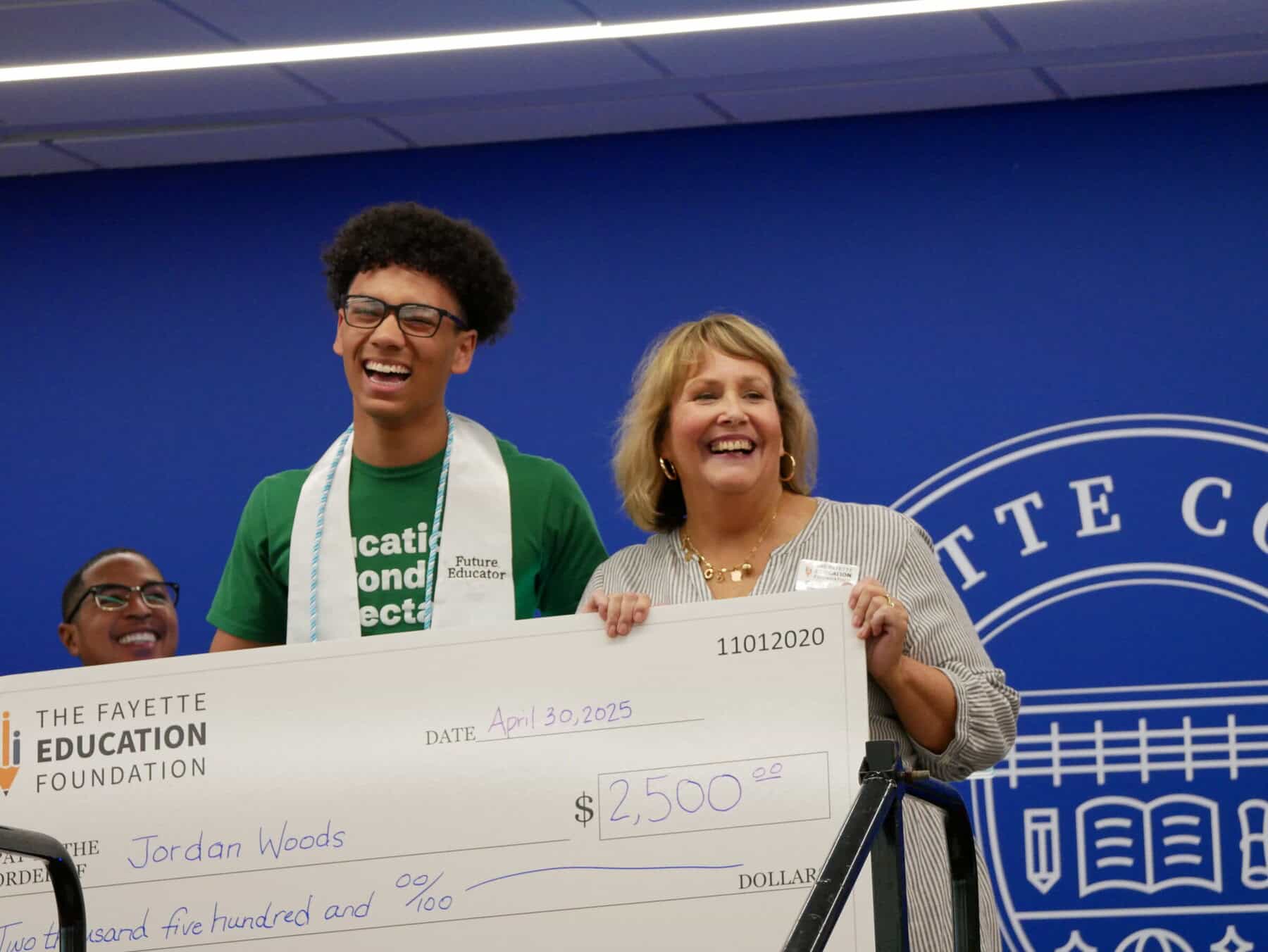 Carrie presenting check to Jordan 2025